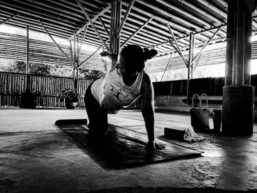 A woman practising a yoga pose on a mat