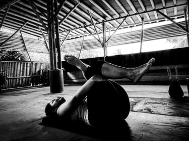 A woman practices a reclining yoga pose
