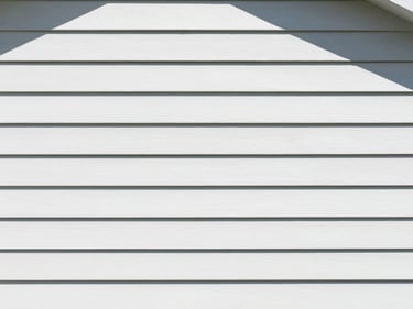 Clean residential house siding, soft-wash, crisp daylight, professional editorial style.