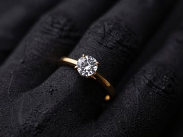 Close-up macro shot of an elegant gold ring with a single large diamond, worn on a hand, dark textured stone backdrop, dramatic low-key lighting, deep black and gold tones, shallow depth of field