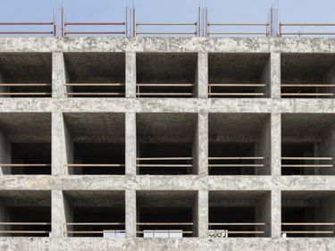 Industrial architectural photography of a concrete building under construction, sharp structural details.