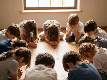 Children gathered in a circle with bowed heads in quiet prayer, soft golden light filtering through a window