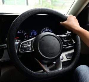 a hand is holding steering wheel