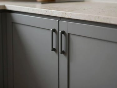 Close-up macro photograph of a premium modular kitchen interior, matte grey cabinet doors with integrated handles, stone-effect countertop surface detail, under-cabinet lighting strip, no people, even studio illumination