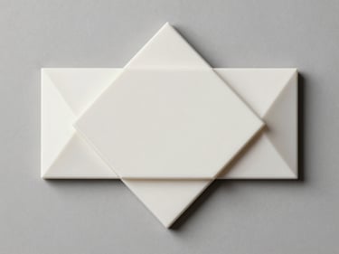 Overhead flat-lay of a custom 3D-printed home decor piece — a geometric wall ornament or nameplate — on a neutral grey surface under studio strobe lighting, clean edges and surface finish clearly visible