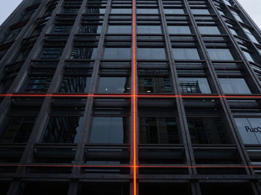 Low-angle wide shot of a steel and glass corporate tower framework, technical wireframe overlay, dark slate tone, orange laser level lines, 35mm