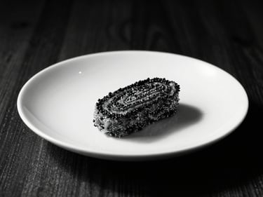 Close-up of a perfectly plated main meal, high-contrast lighting, deep blacks, crisp whites, warm wood accents, strong shadows, 35mm lens