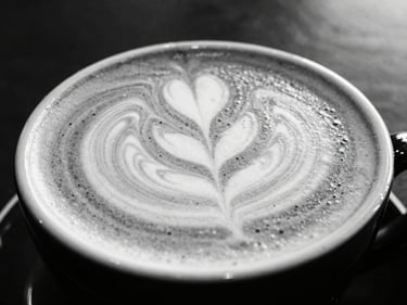 Close-up of a freshly pulled latte with intricate foam art, minimalist monochrome setting, high-contrast lighting, 35mm lens.
