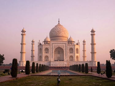 Symmetrical shot of the Taj Mahal from a quiet garden across the Yamuna River during sunrise, soft pink mist, elegant framing
