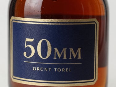 Macro shot of a vintage cognac bottle with an intricate label, soft reflections on the glass, rich brown tones.