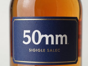 Close-up of a premium amber-colored single malt whisky bottle, soft studio lighting, amber liquid visible, crisp label details.