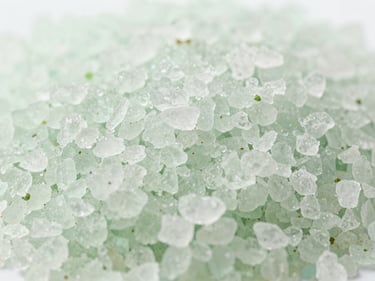 Macro shot of exfoliating body scrub texture with natural salt grains, clean daylight