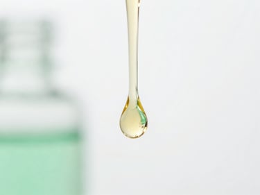 Macro shot of golden hair oil droplet falling, clinical white background, precise depth of field