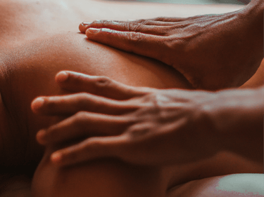 Close-up of a professional therapist performing a deep tissue shoulder massage for muscle relief.