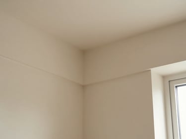 Close-up of seamless wall moulding corners on a sand-colored wall, clean joints, natural light.