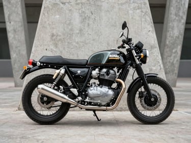 Royal Enfield Super Meteor 650 in profile against architectural concrete pillar, diffused daylight, parallel-twin engine visible, clean exhaust line, no rider