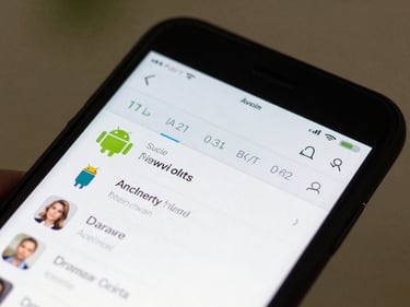 Android phone screen showing a clean data-light news reader interface, tight crop of the display in natural daylight, fingers visible at screen edge mid-scroll