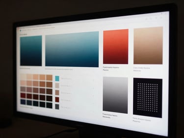 Extreme close-up of a high-resolution screen displaying a meticulously laid-out brand identity system — color fields, type specimens, spacing rules — in a dark studio environment with focused directional light