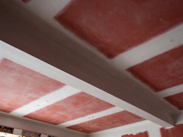 Freshly taped and mudded drywall joints on a clean high ceiling, smooth compound lines, architectural lighting