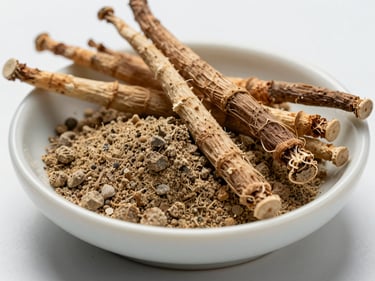 Extreme close-up of raw ashwagandha root and powder in a small clean ceramic dish, cool diffused studio lighting, overhead framing on white surface, ingredient-texture detail