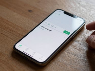 Android phone screen displaying a simple unit-converter app interface, phone lying on a wooden table under natural window light, fingers visible at the edge of frame