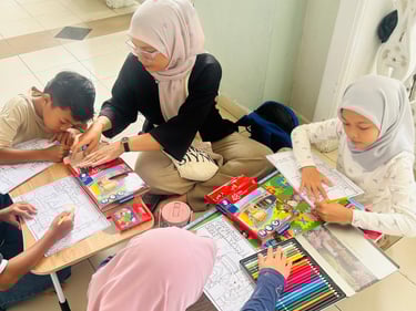 A teacher in a hijab helps young students with coloring activities using colored pencils.