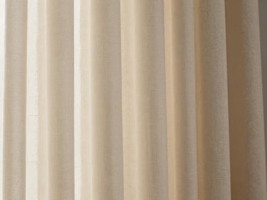 Extreme close-up of heavyweight curtain fabric weave — silk-blend fabric with a subtle geometric texture, soft north-facing daylight revealing thread structure and a warm ivory tone, flat-lay framing