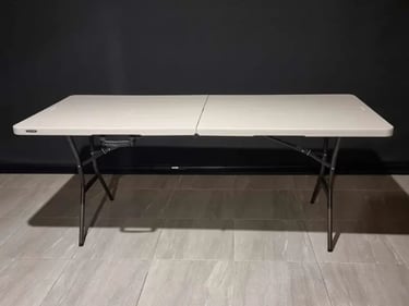 Folding lifetime table with a white spandex cover available for hire in Redlands.