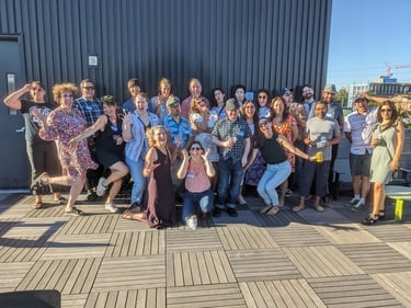 a group of people at the Portland Design Thinkers rooftop happy hour, posing and making silly faces
