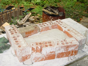 the wax carafe buried in plaster to create the mould