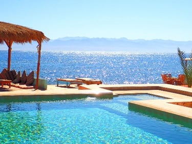 Fresh water swimming pool next to a beach bungalow with a shaded Arisha at Bedouin Star