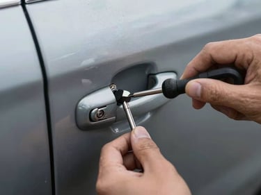 Tight shot of a locksmith tool inserted into a car door lock mechanism, vehicle door panel visible, harsh direct light, hands in focus, documentary style