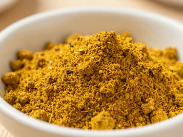 Macro photograph of a vibrant yellow curry and seasoning powder mix, shallow depth of field, natural light.