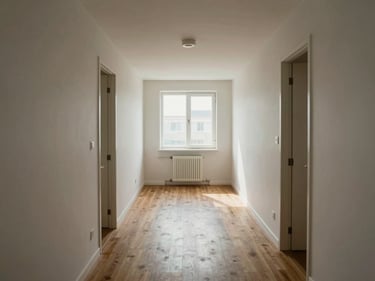 Wide shot of a compact apartment living area arranged for clear circulation paths, natural light from a single window, minimal furniture showing spatial logic, no people
