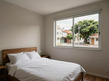 Bedroom of a two-bedroom apartment in São Paulo with natural daylight, neutral tones, practical layout, window overlooking a residential street with trees