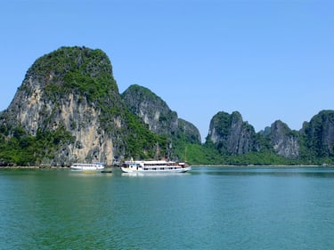 a boat in the water with a mountain in the background