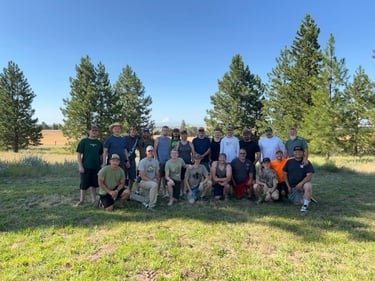 a group of people standing in a field with trees