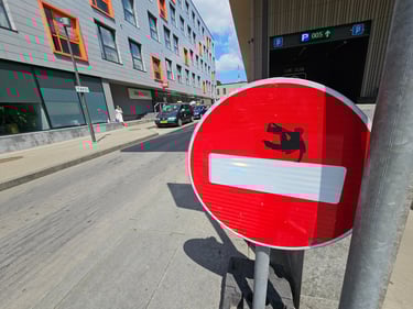 a red and white sign with a picture of a man on a skateboard