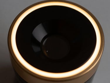 Macro close-up of CURAZET aesthetic device, gold rim lighting, black mirror glass finish, 85mm