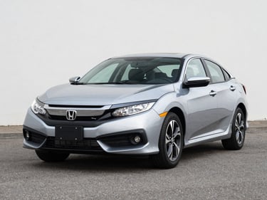 Three-quarter front view of a clean 2020 Honda Civic in silver on a bright outdoor lot under even daylight, neutral asphalt background, no people