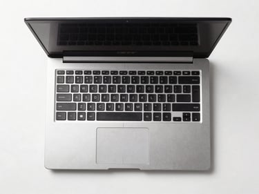 Overhead straight-on product shot of an Acer refurbished laptop open on a white surface, clean studio lighting, no reflections
