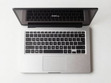 Overhead straight-on product shot of a Dell refurbished laptop open on a white surface, clean studio lighting, no reflections