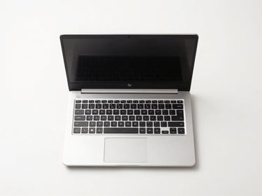 Overhead straight-on product shot of an HP refurbished laptop open on a white surface, clean studio lighting, no reflections