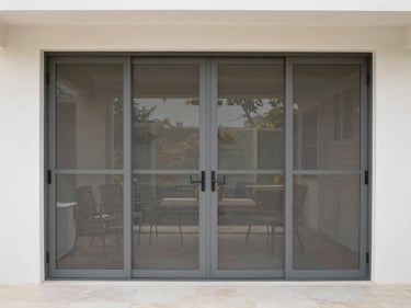 Wide shot of a modern patio with a weatherproof screen door seamlessly integrated, natural daylight, clean neutral tones