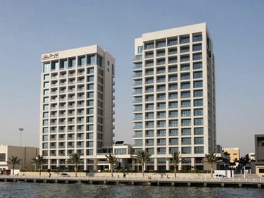 Exterior elevation of a newly completed residential building in Business Bay, photographed from across the canal in natural daylight, emphasising structural geometry and window proportions