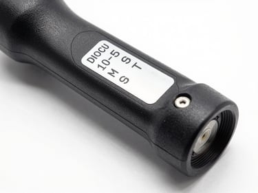 Close-up studio shot of a steering rack assembly on white surface, part identification label clearly readable, sharp shadow definition from studio strobe