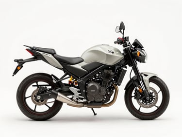 Overhead studio shot of a 160cc naked street motorcycle, neutral white surface, even daylight, full bike visible from above showing tank and instrument cluster
