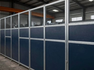 Industrial partition wall made of steel mesh and solid panels, separating areas in a factory, sharp focus, technical detail.