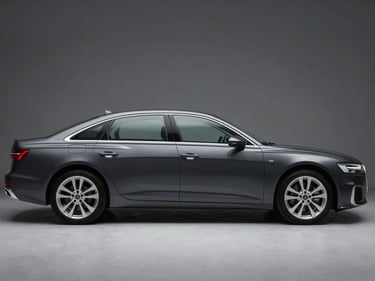 Front three-quarter driver-side profile of a dark grey Audi A6 sedan, studio strobe lighting, full vehicle profile, squared frame, no artistic angle