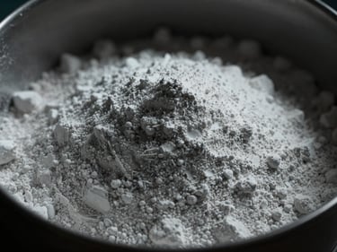 Close-up of pure white chemical powder in a dark container with high-contrast lighting.